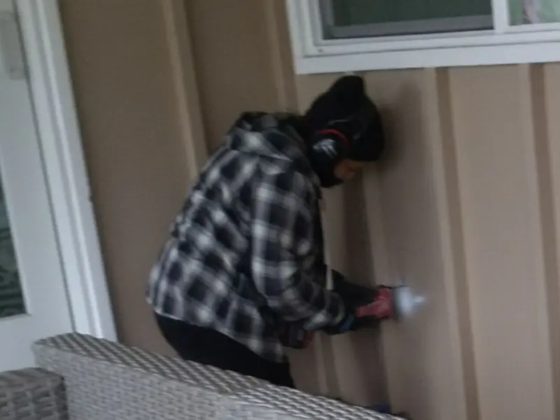 Professional electrician installing an exterior outlet in Palacios
